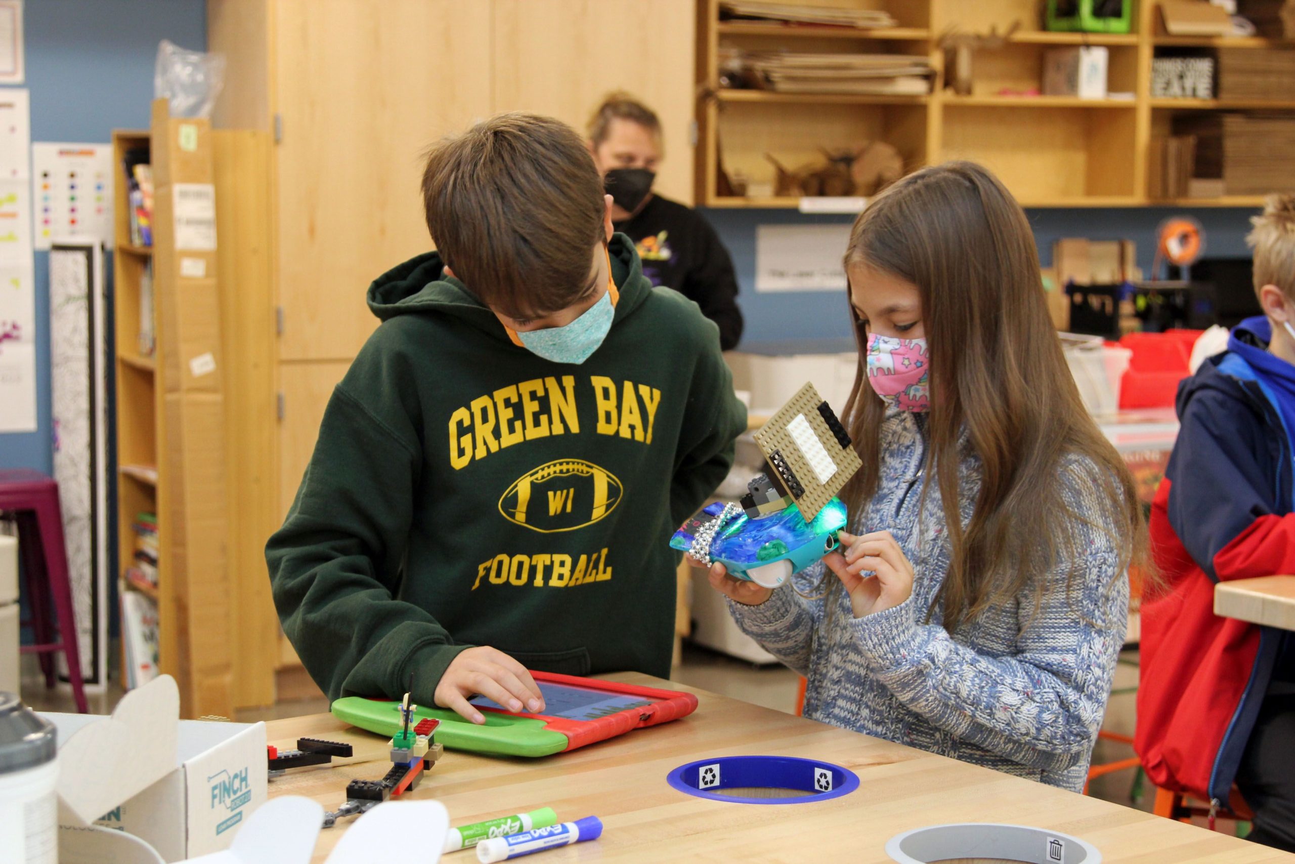 Students collaborating with the Finch robot
