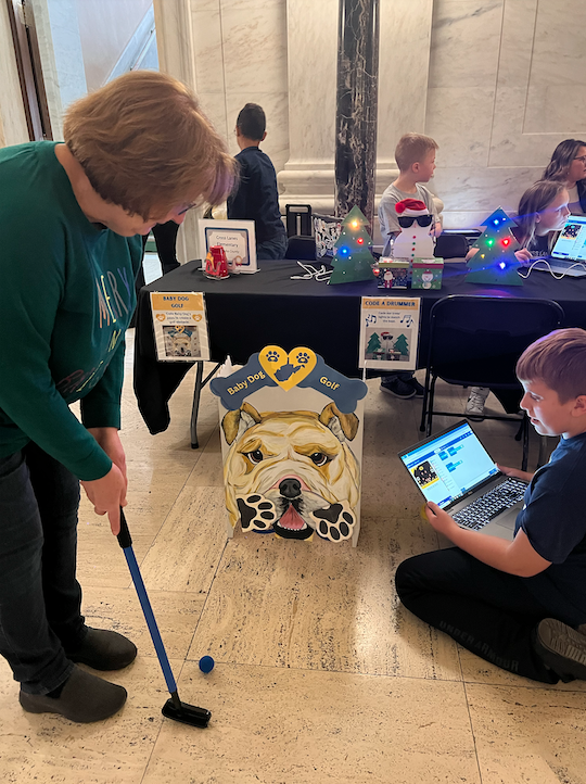 Student presenting a robotics project at the capitol