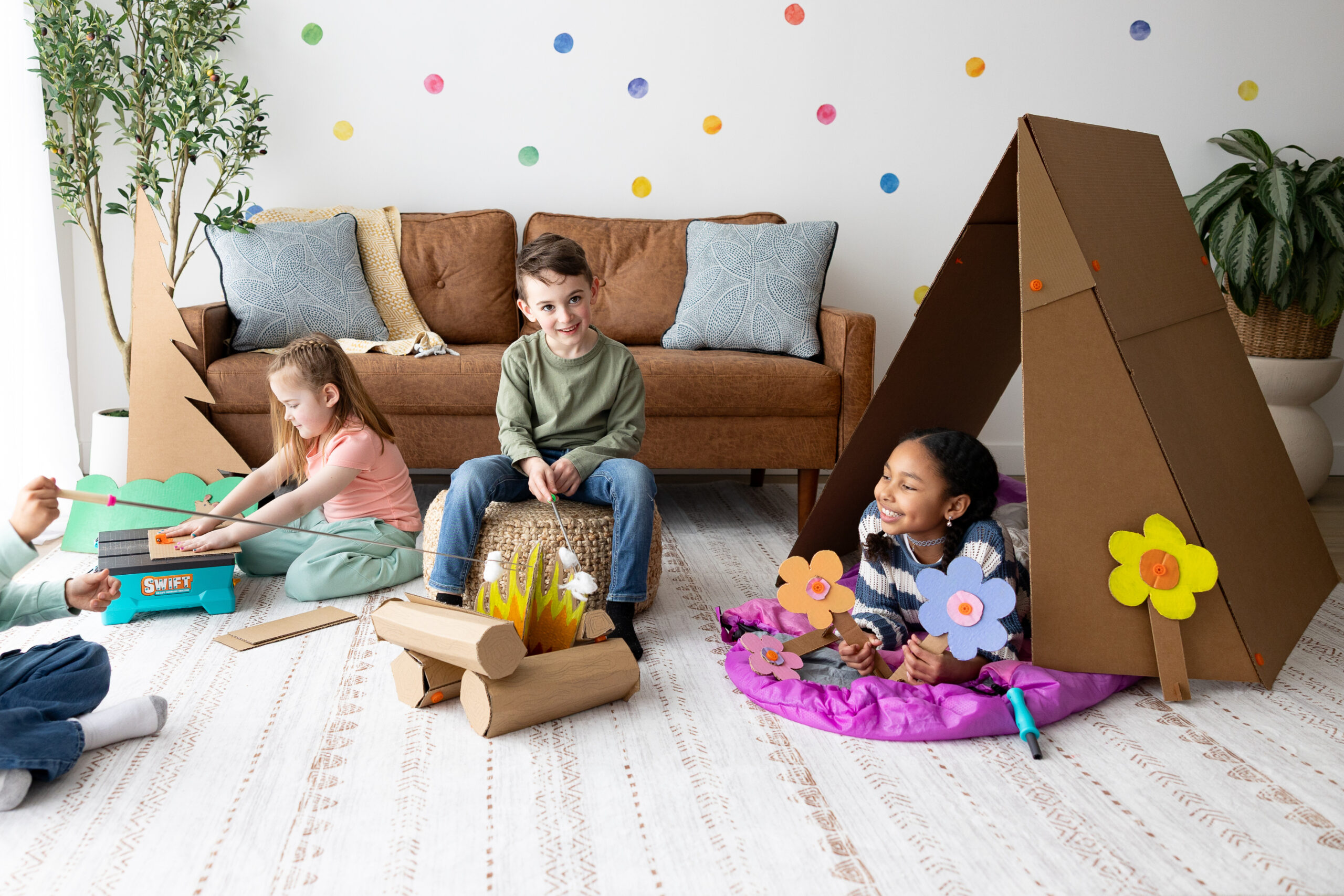 Kids playing with cardboard builds in a living room