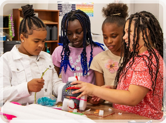 Students testing their spacecraft design in a classroom
