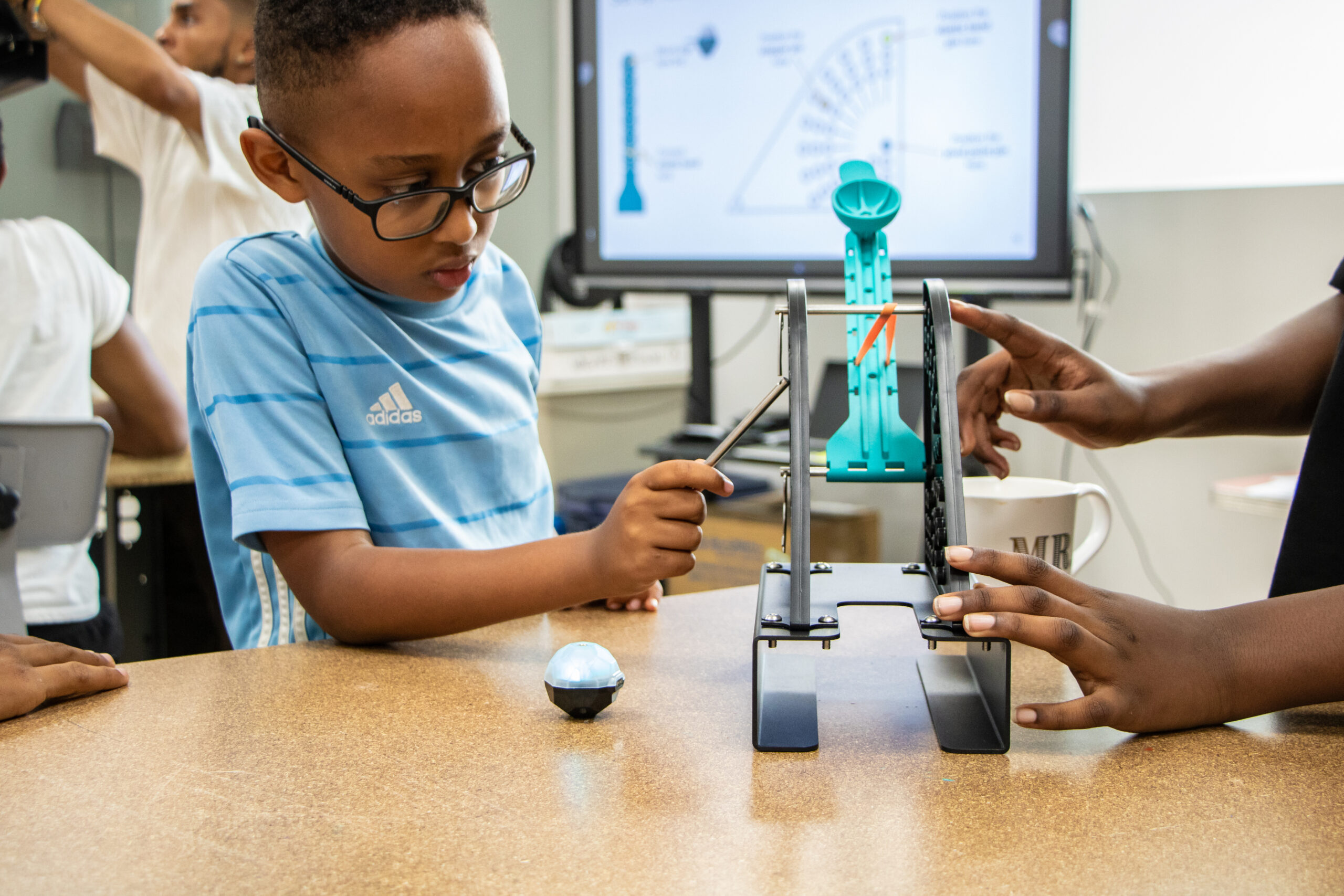 Student exploring a DataSnap projectile kit in the classroom